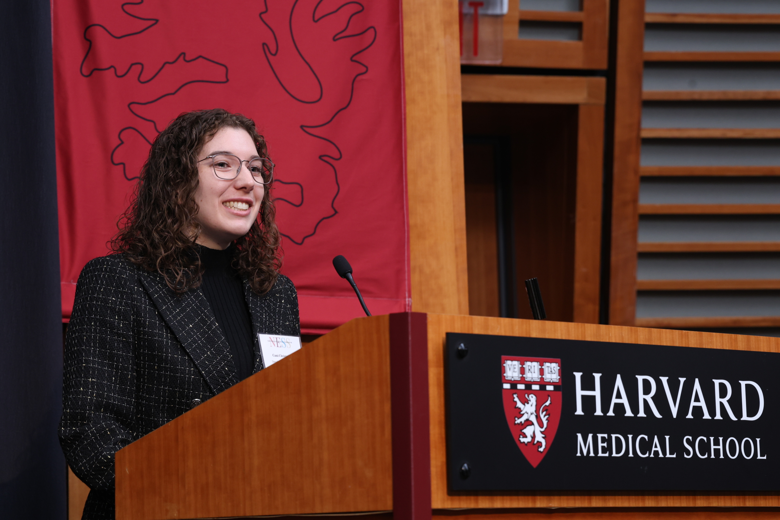 student speaking at podium during science symposium