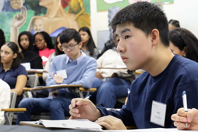 students at presentation, taking notes