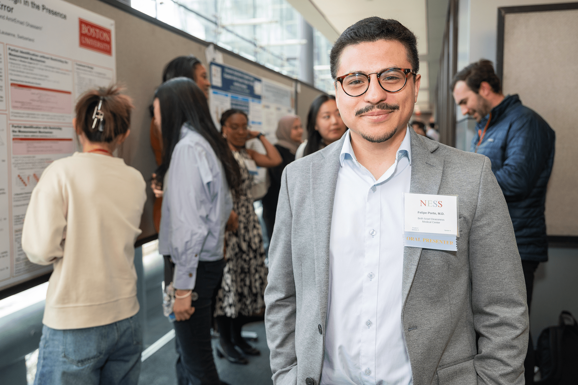 student posing for camera at science symposium