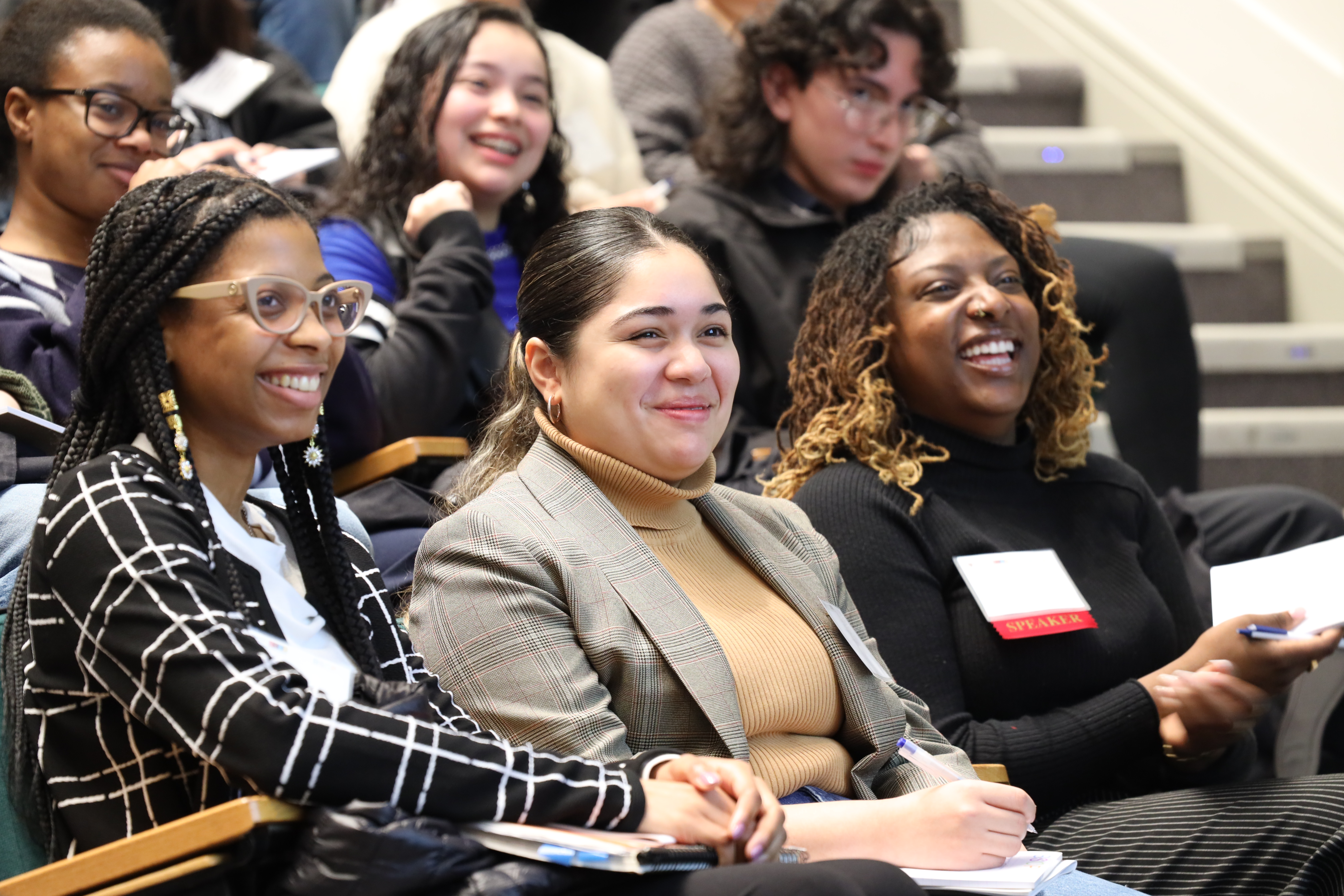 stduents smiling in lecture hall